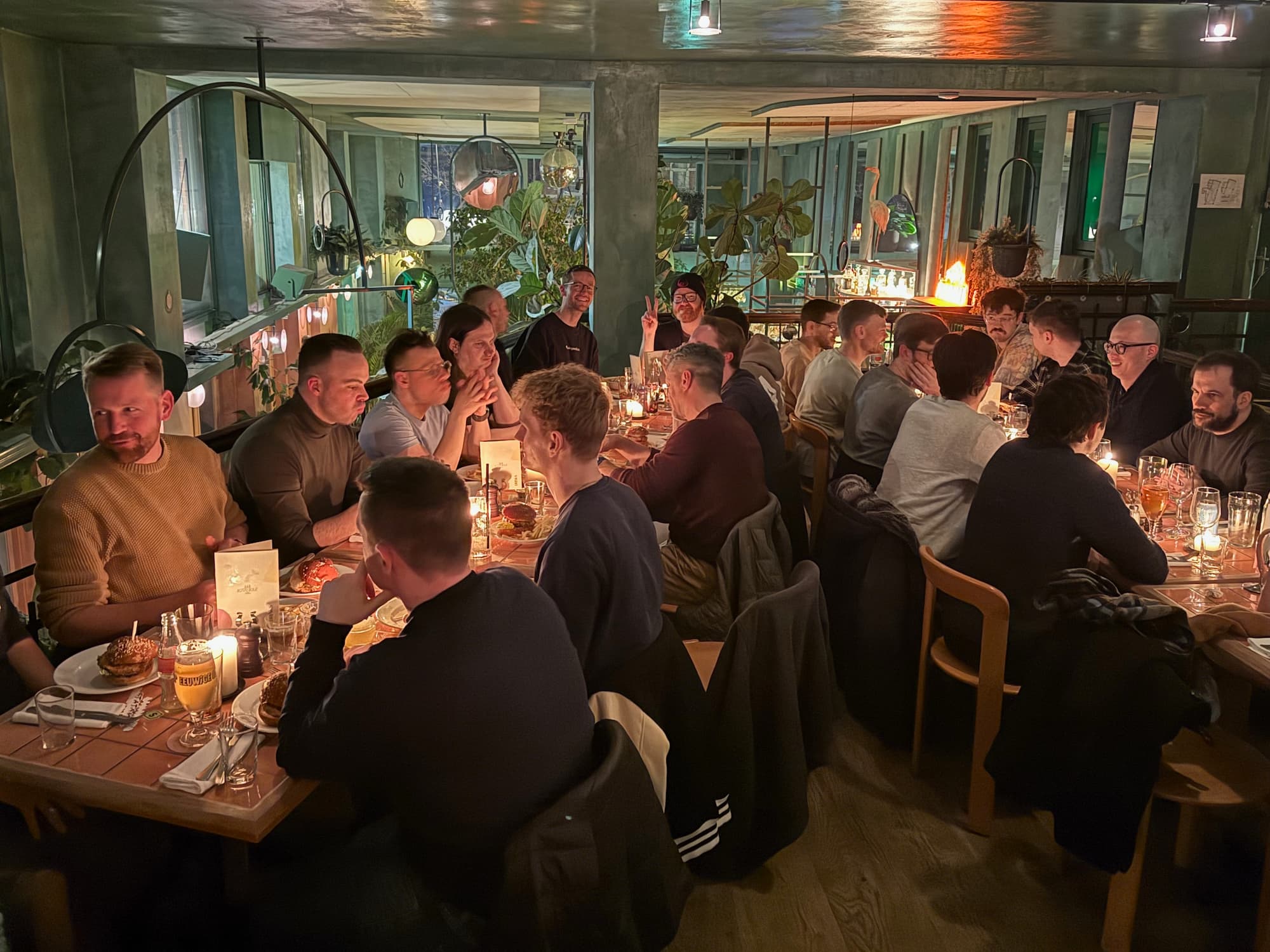 A group photo of Statamic community members attending the Laracon 2026 Statamic meetup in a bar